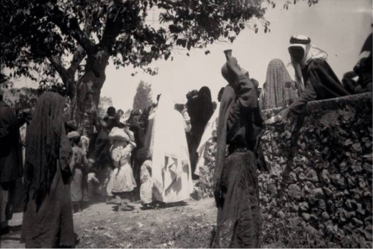 Bringing water from the well before breaking the fast during Ramadan. Akka, 1930.