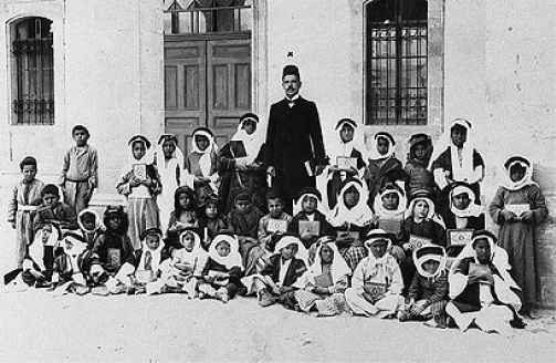 The first teacher in Beersheba, Jarallah al-Hanafi Effendi, and his students, sons of tribal sheikhs, 1907