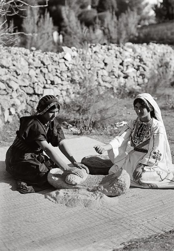 Rubbing and grinding wheat in Jerusalem. 1920