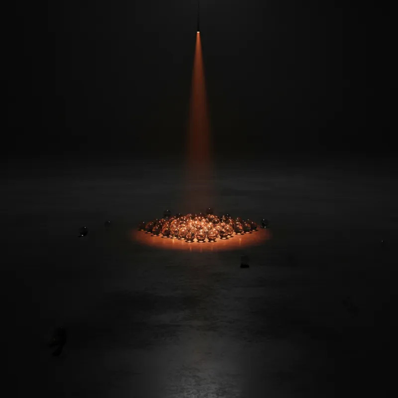 Dozens of glass marbles gathered in one corner of a dark room with an almost imperceptibly tilted floor, lit by a single warm orange light