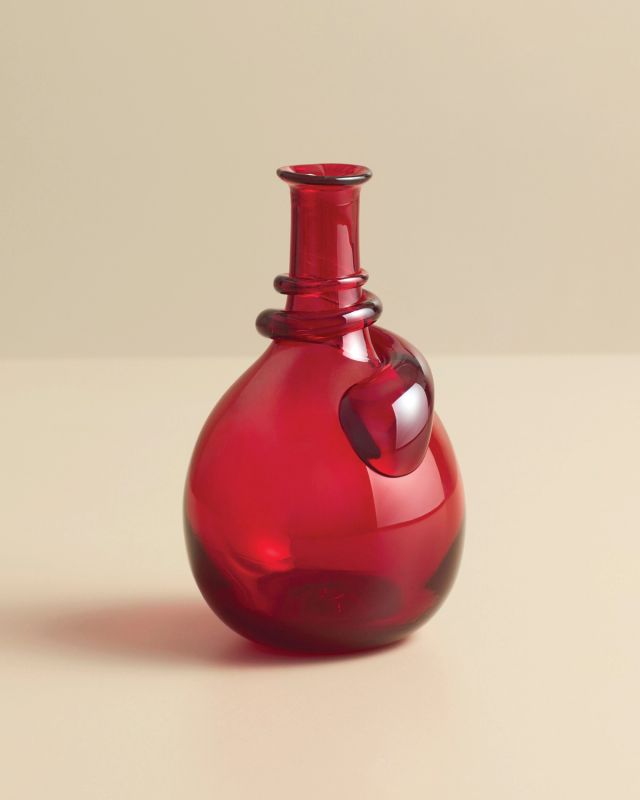 Hand-blown red glass vase featuring a rounded silhouette and sculptural detail near the neck.