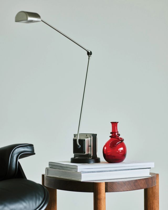 Hand-blown red glass vase featuring a rounded silhouette and sculptural detail near the neck.
