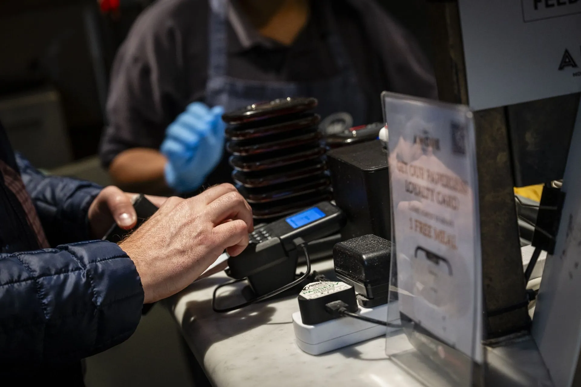 Customer tapping card at food hall counter