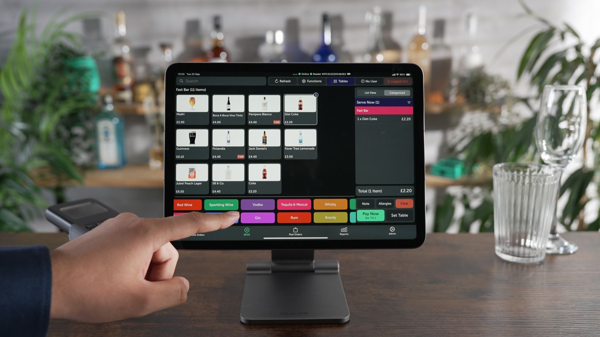 iPad EPOS on modern stand showing drinks menu at a bar