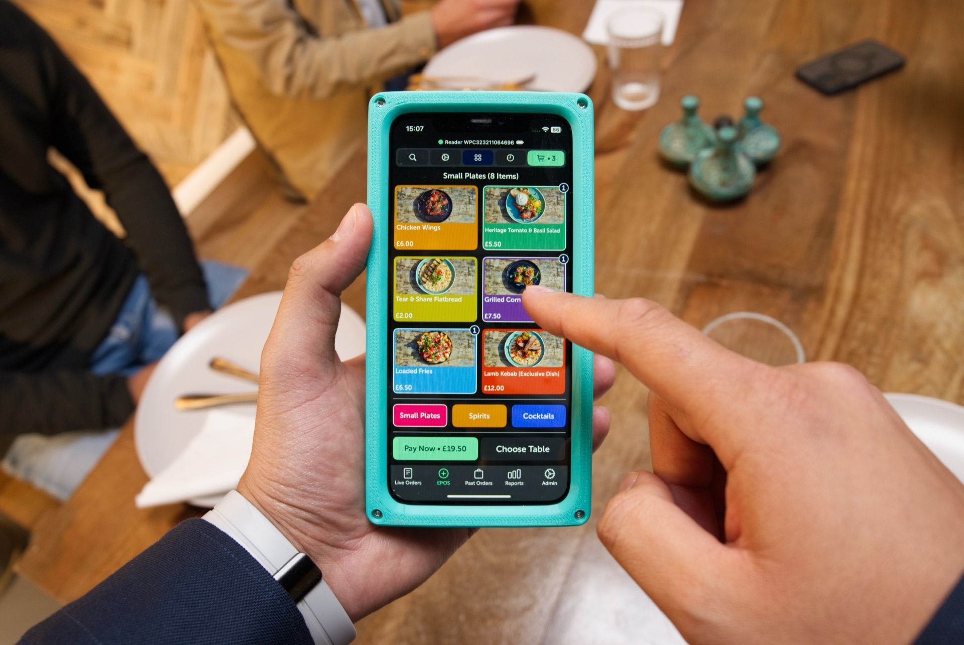 DinesPad handheld terminal showing menu items