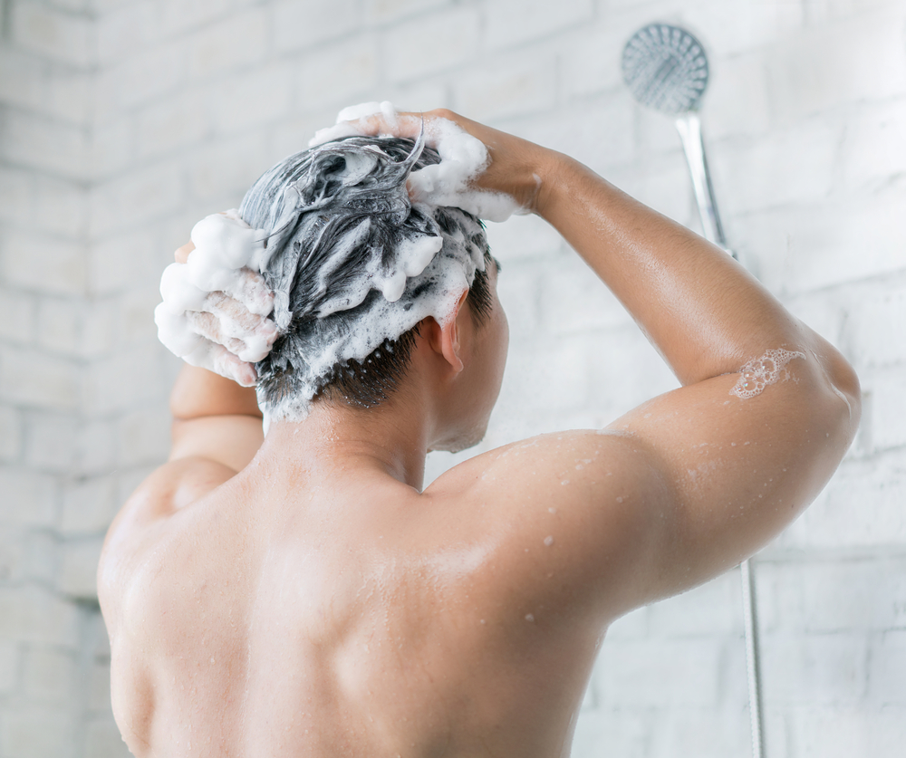 man in the shower washing hair