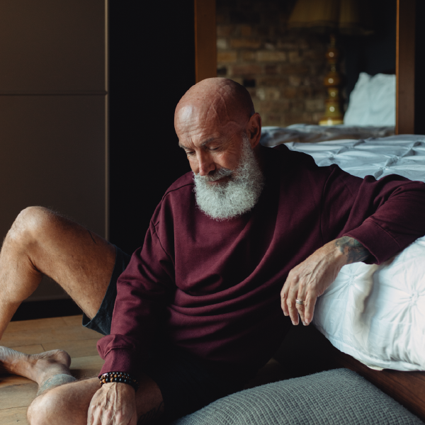 Men with the beer sitting on the floor