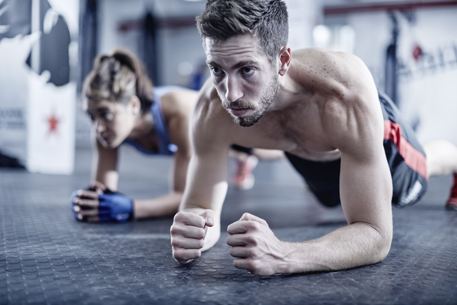 couple in gym doing plank