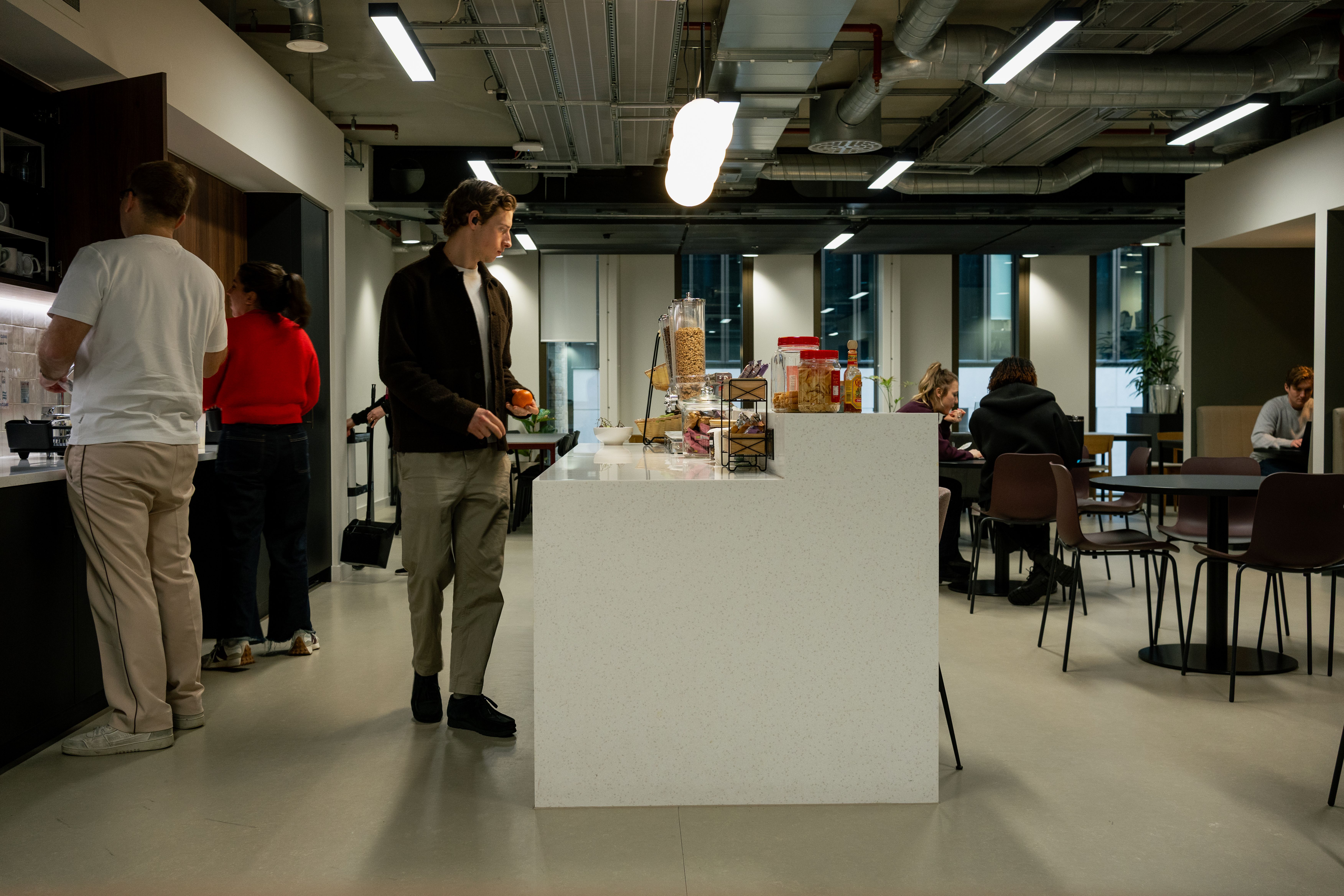 The Voy office kitchen with people enjoying drinks and snacks