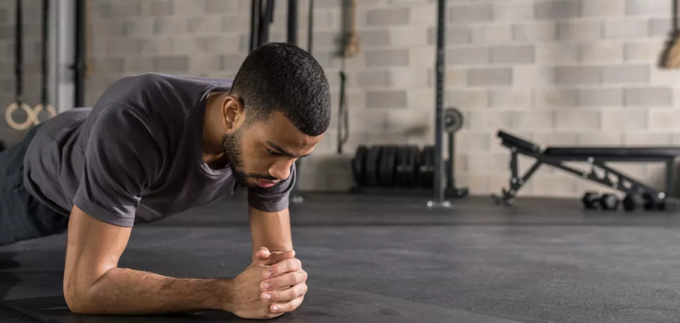 Man doing plank in the gym