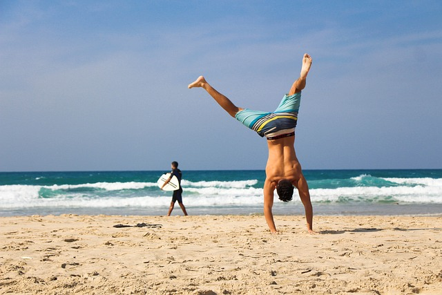 Man handstand on the beach