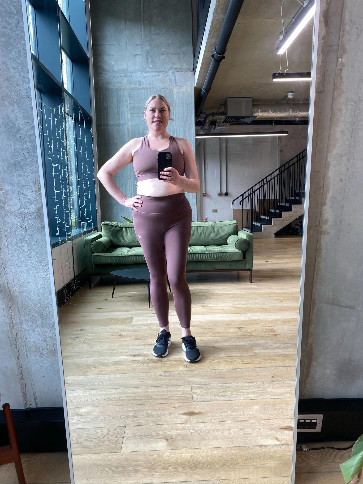 Full-body mirror photo. Person is wearing close-fitting athletic clothing, with face clearly visible.