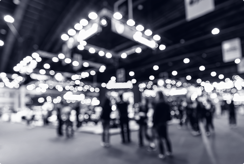 Conference expo hall with attendees exploring booths and displays