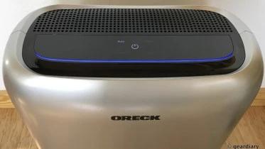Oreck portable air purifier on a wood floor