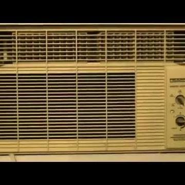 Old beige window air conditioner