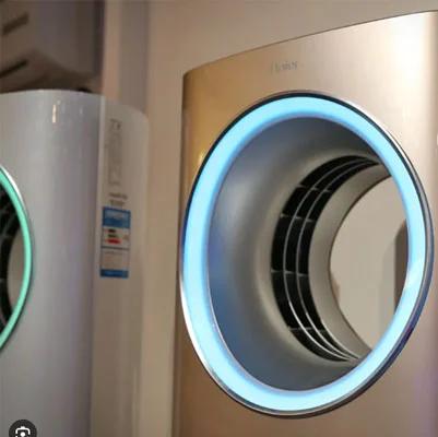 Modern wall-mounted air conditioner with a round vent glowing blue