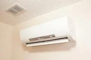 Wall-mounted ductless mini-split unit near a ceiling