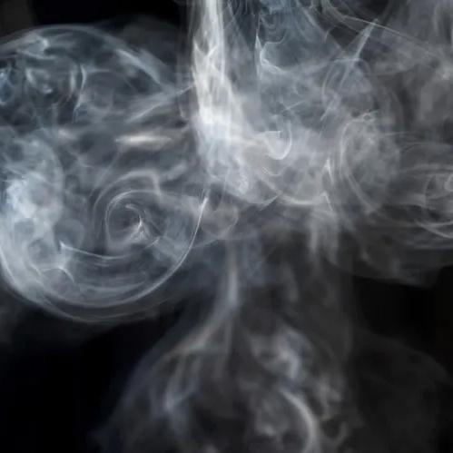 Swirl of white smoke against a black background