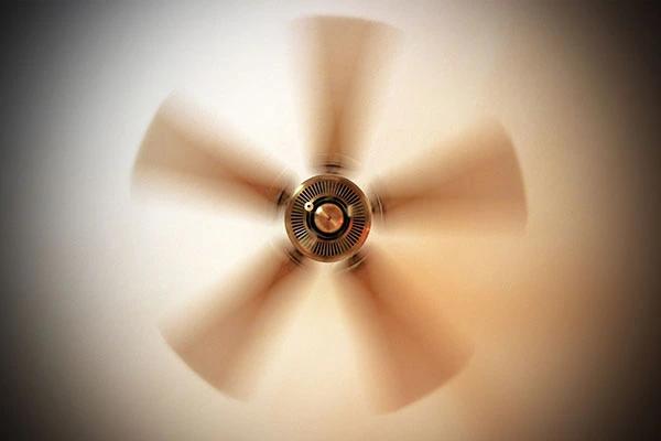 Ceiling fan blades spinning in a blur