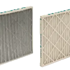 A dirty pleated air filter next to a clean one