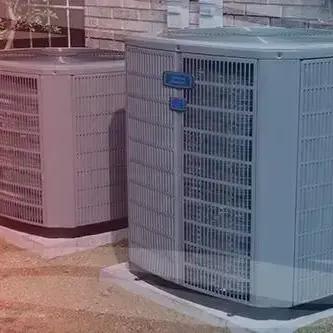 Two outdoor air conditioning units on concrete pads beside a house