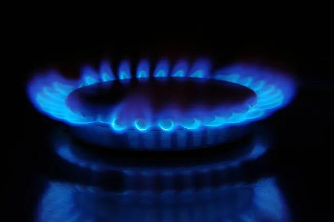 Blue flames on a gas burner in the dark