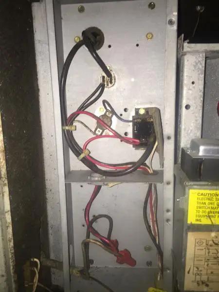 Open electrical panel of an air handler showing wiring and a contactor