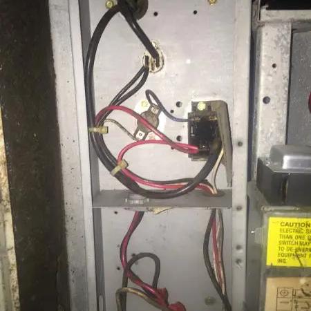 Open electrical panel of an air handler showing wiring and a contactor
