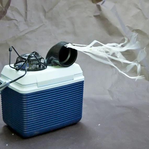 Homemade cooler-box air conditioner with a fan blowing streamers