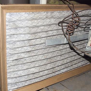 Air filter installed inside a furnace with wiring visible