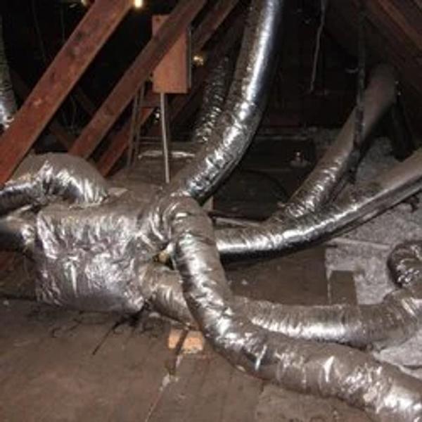 Tangle of insulated flexible ducts in an attic