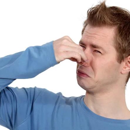 Man pinching his nose against a bad smell