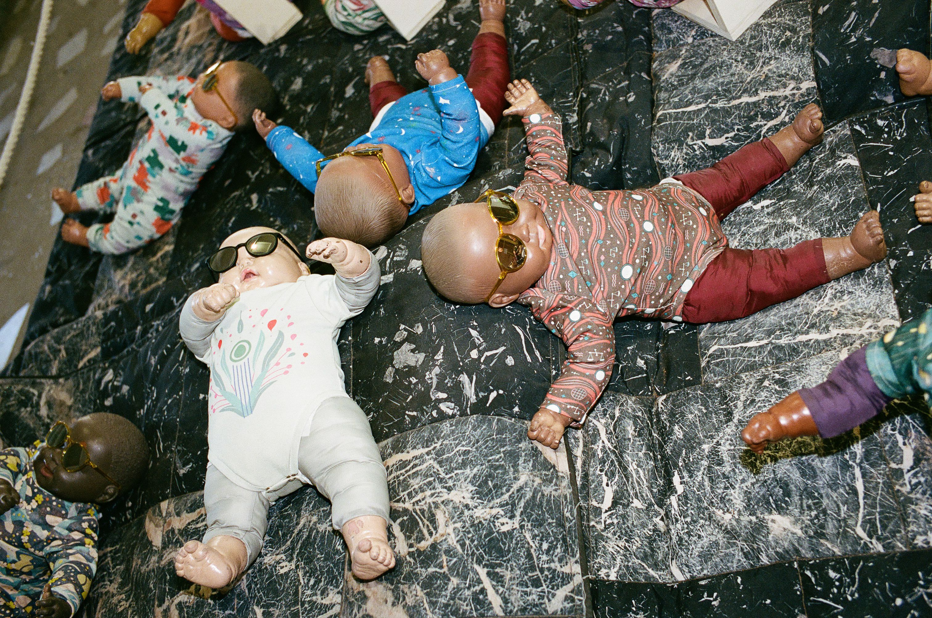 Baby dolls wearing sunglasses at the Japanese Pavilion, Grass Babies, Moon Babies.