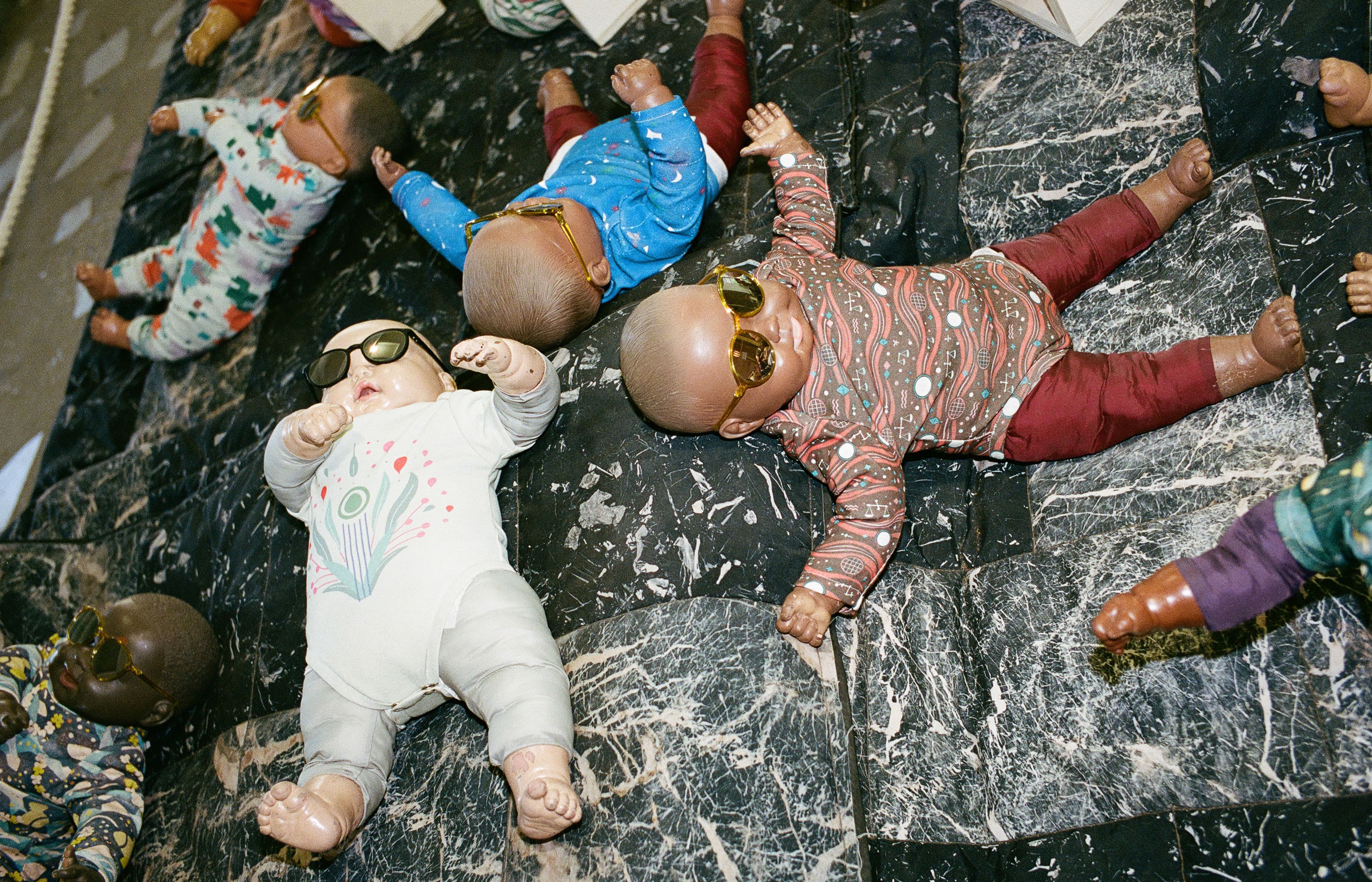Baby dolls wearing sunglasses at the Japanese Pavilion, Grass Babies, Moon Babies.