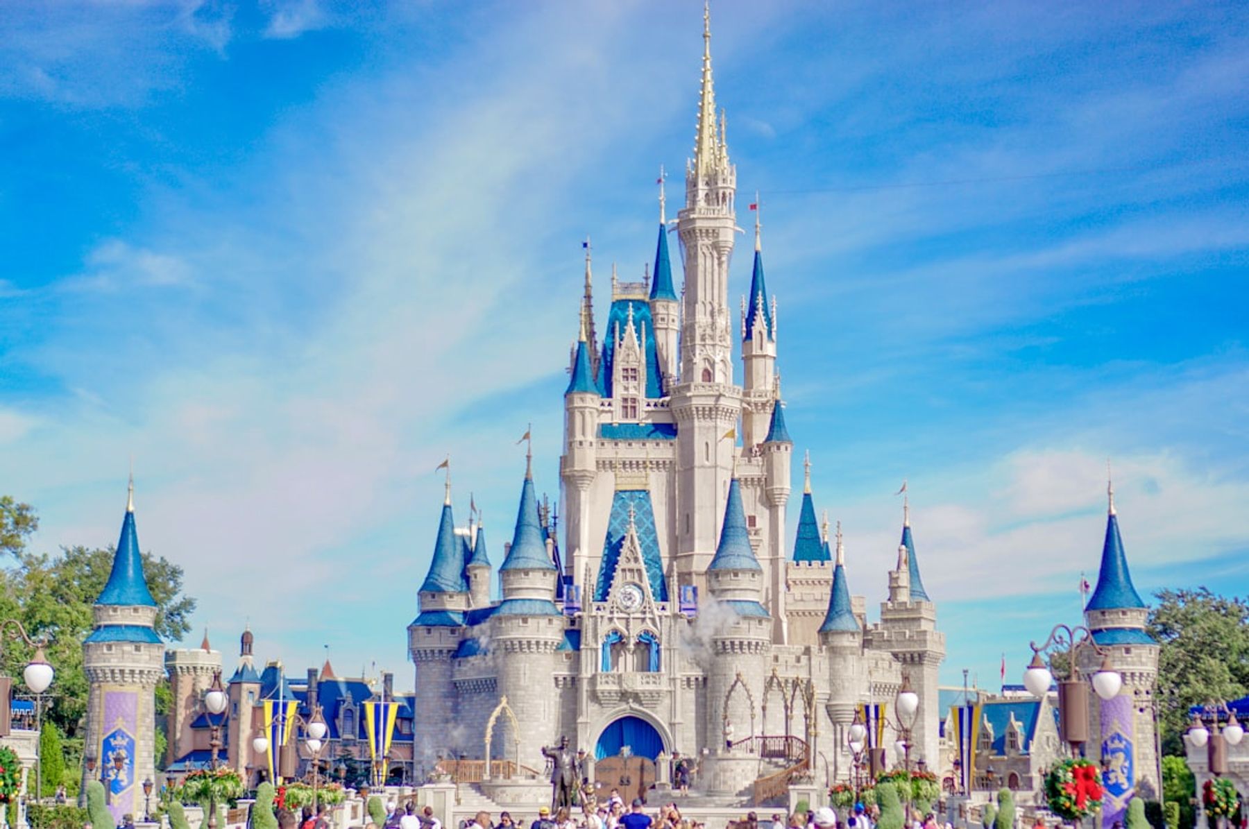 Cinderella Castle at Walt Disney World's Magic Kingdom, its blue turrets against a clear sky, seen head-on from Main Street