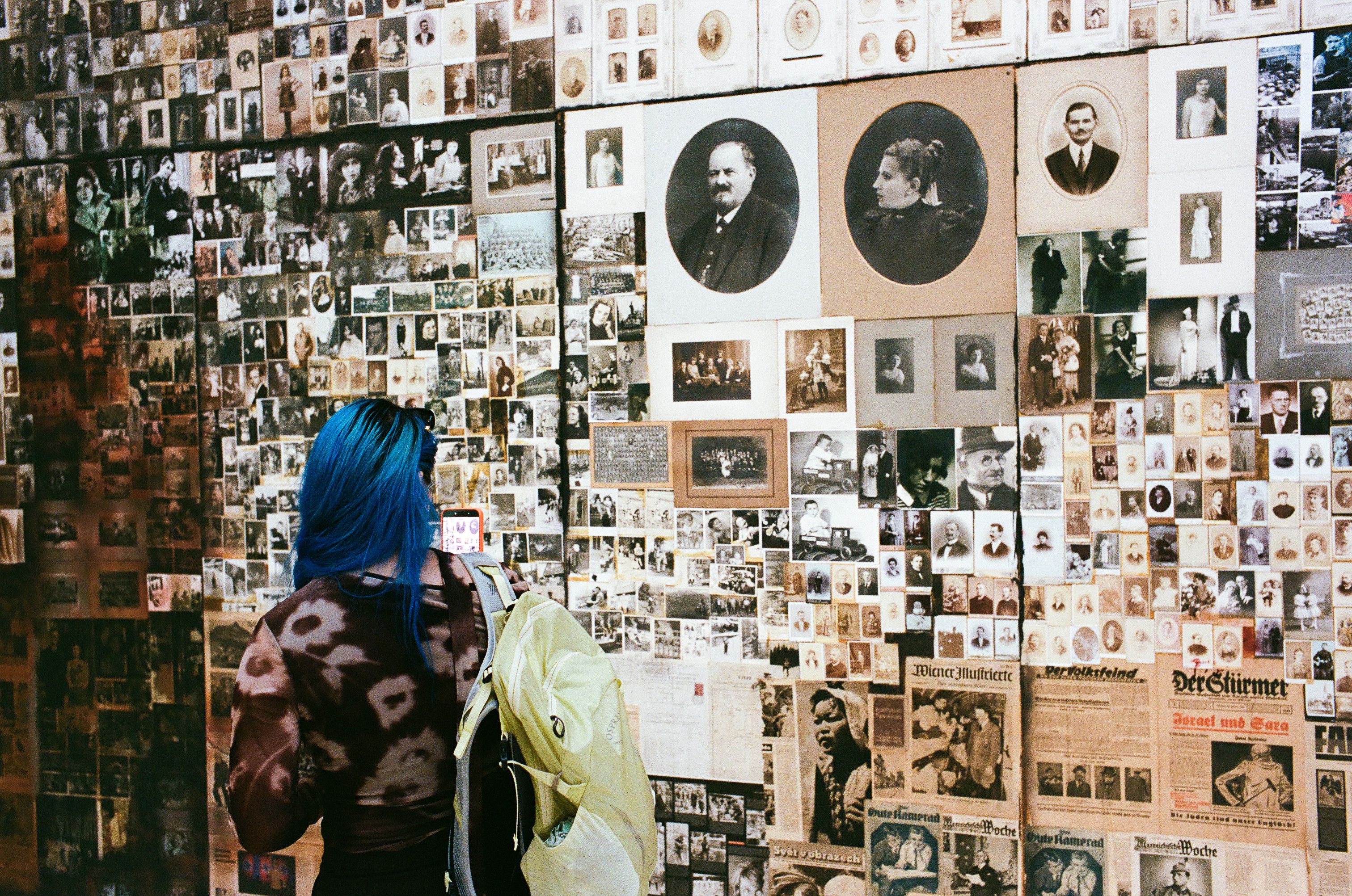 Layers of archival images and a visitor at the Serbian Pavilion.