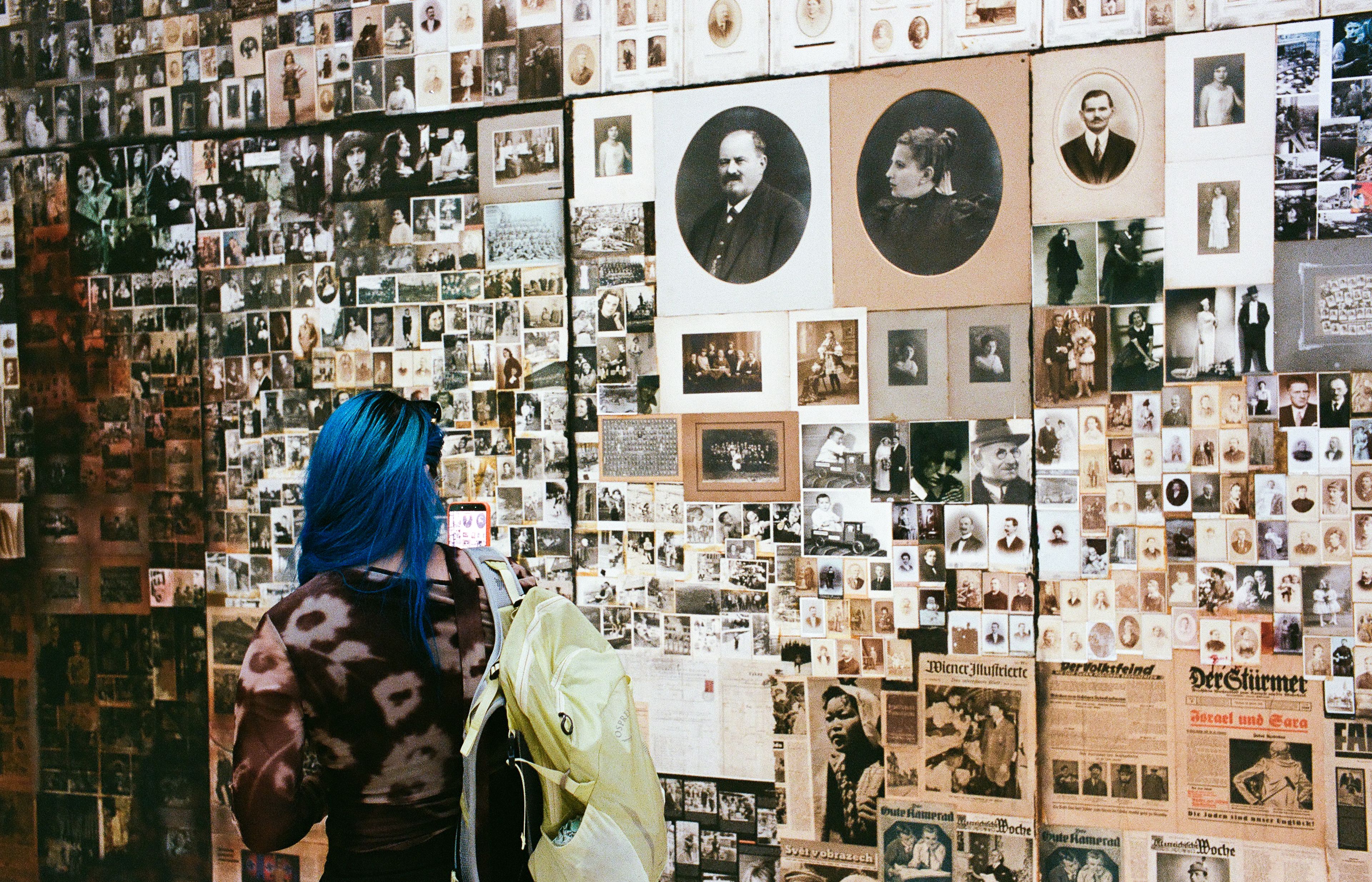 Layers of archival images and a visitor at the Serbian Pavilion.