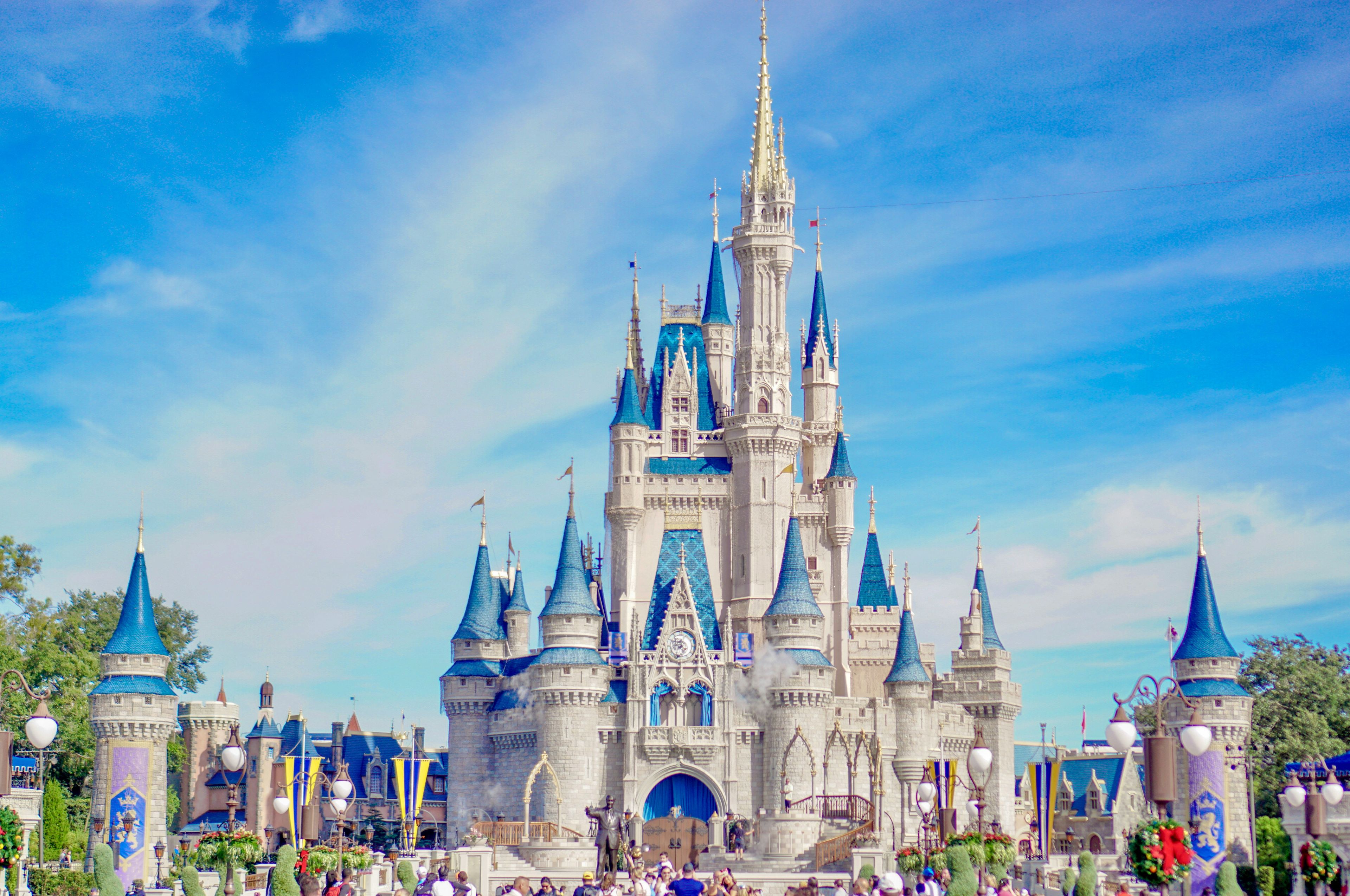 Cinderella Castle at Walt Disney World's Magic Kingdom, its blue turrets against a clear sky, seen head-on from Main Street