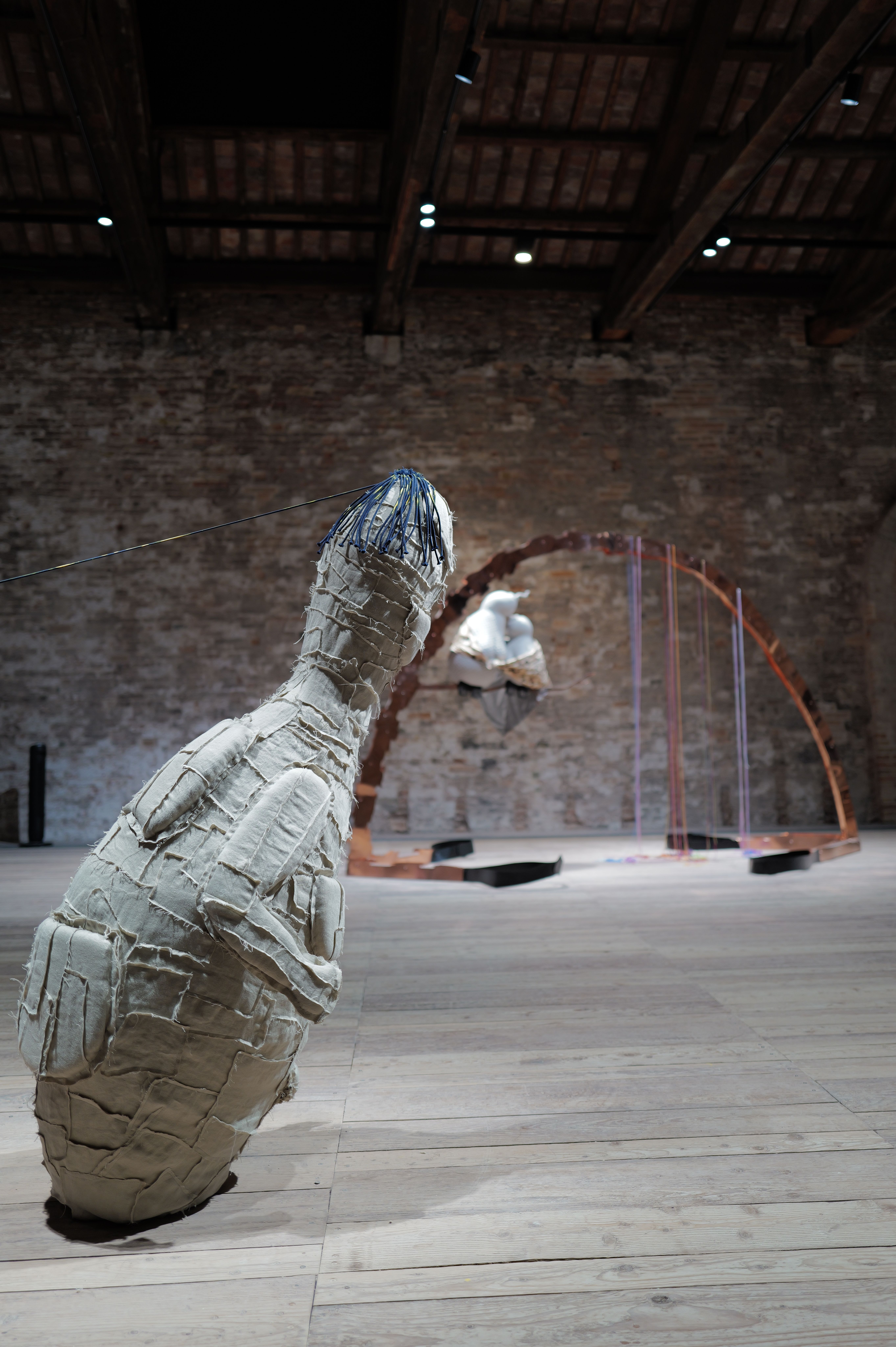 A stitched sculptural form inside one of the Arsenale’s historic exhibition halls.