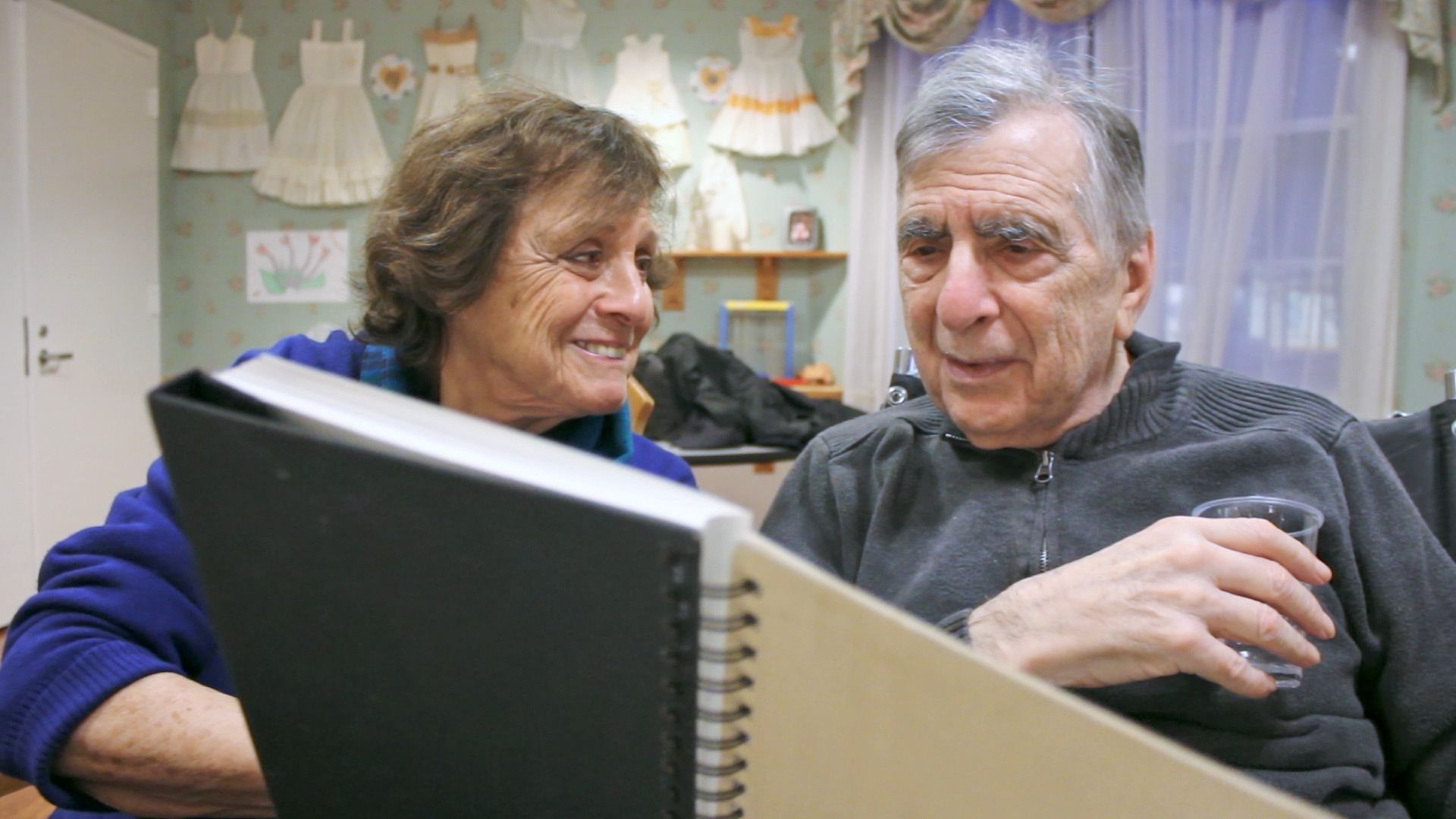 Connie holding up an old photograph of Mel