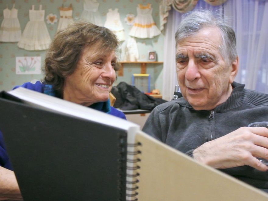 Connie holding up an old photograph of Mel