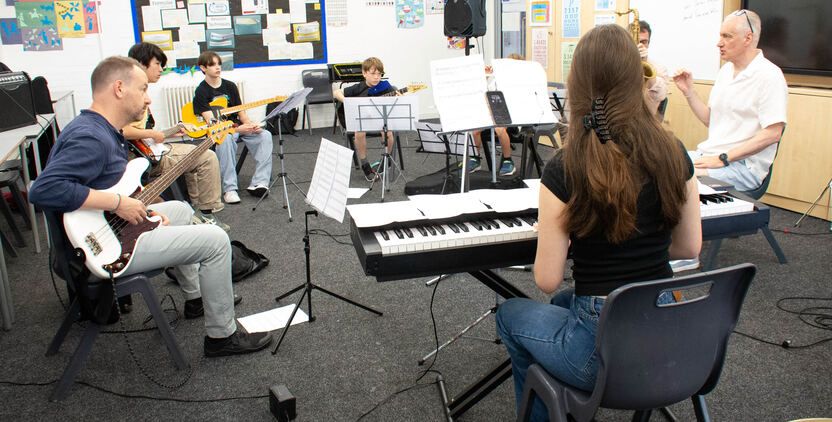 Young musicians rehearsing together as a band.