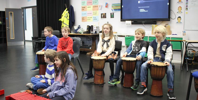 Young children exploring music together.