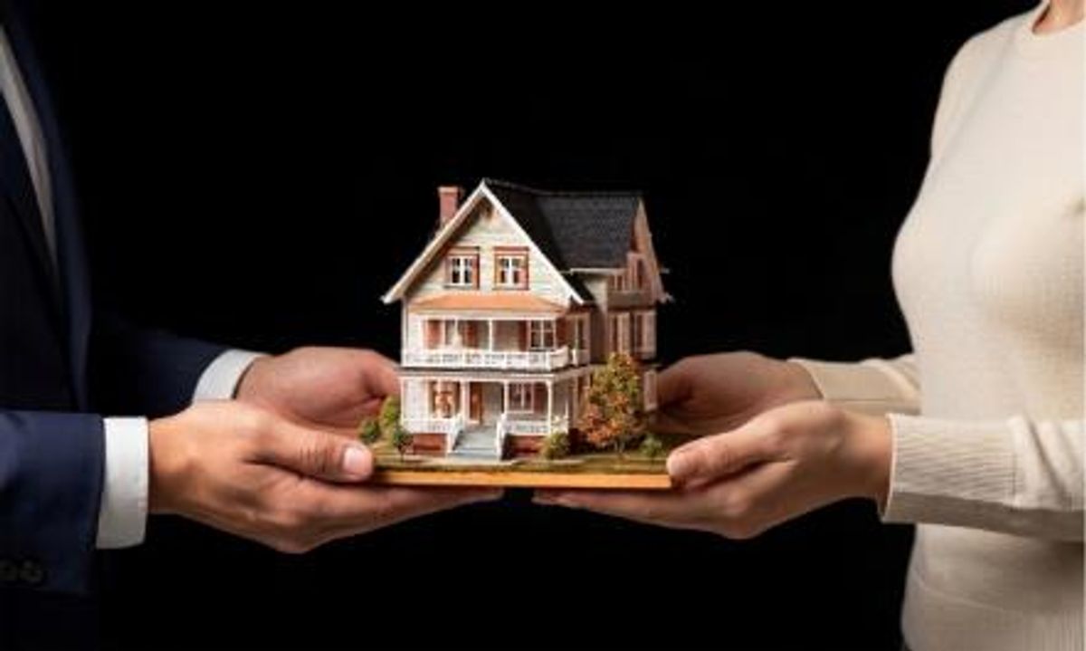 hand holding house model showing hyper realistic 8k walkthroughs