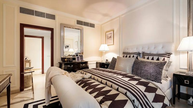 Modern master bedroom with large windows and garden view in a ground floor 25x50 house plan featuring natural light and ventilation