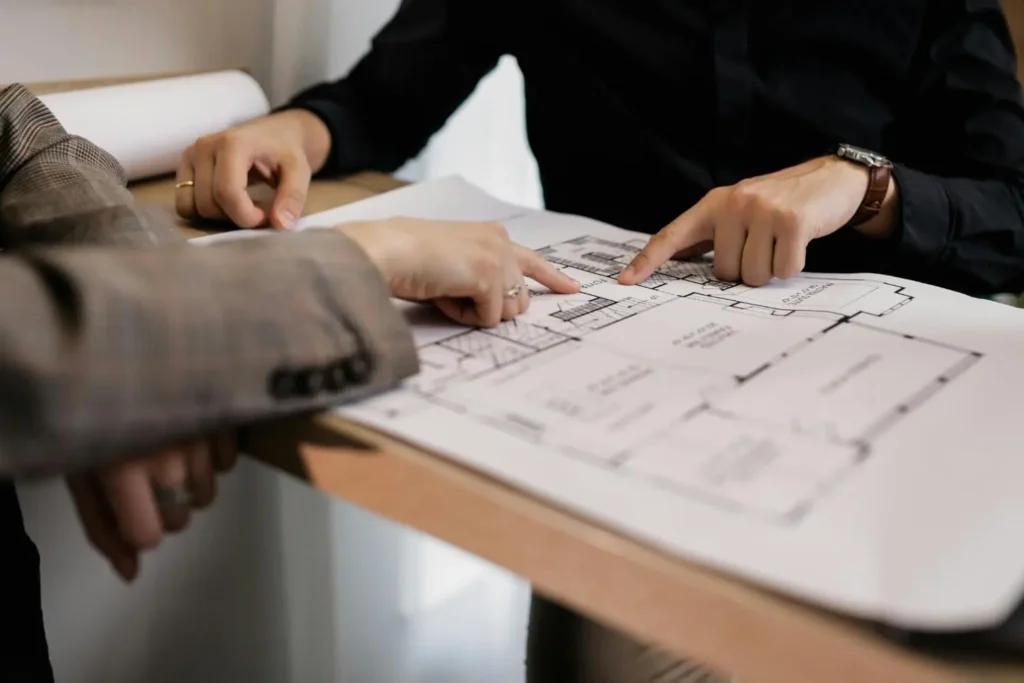 Architect reviewing hand-drawn floor plan sketches for AI-powered home design