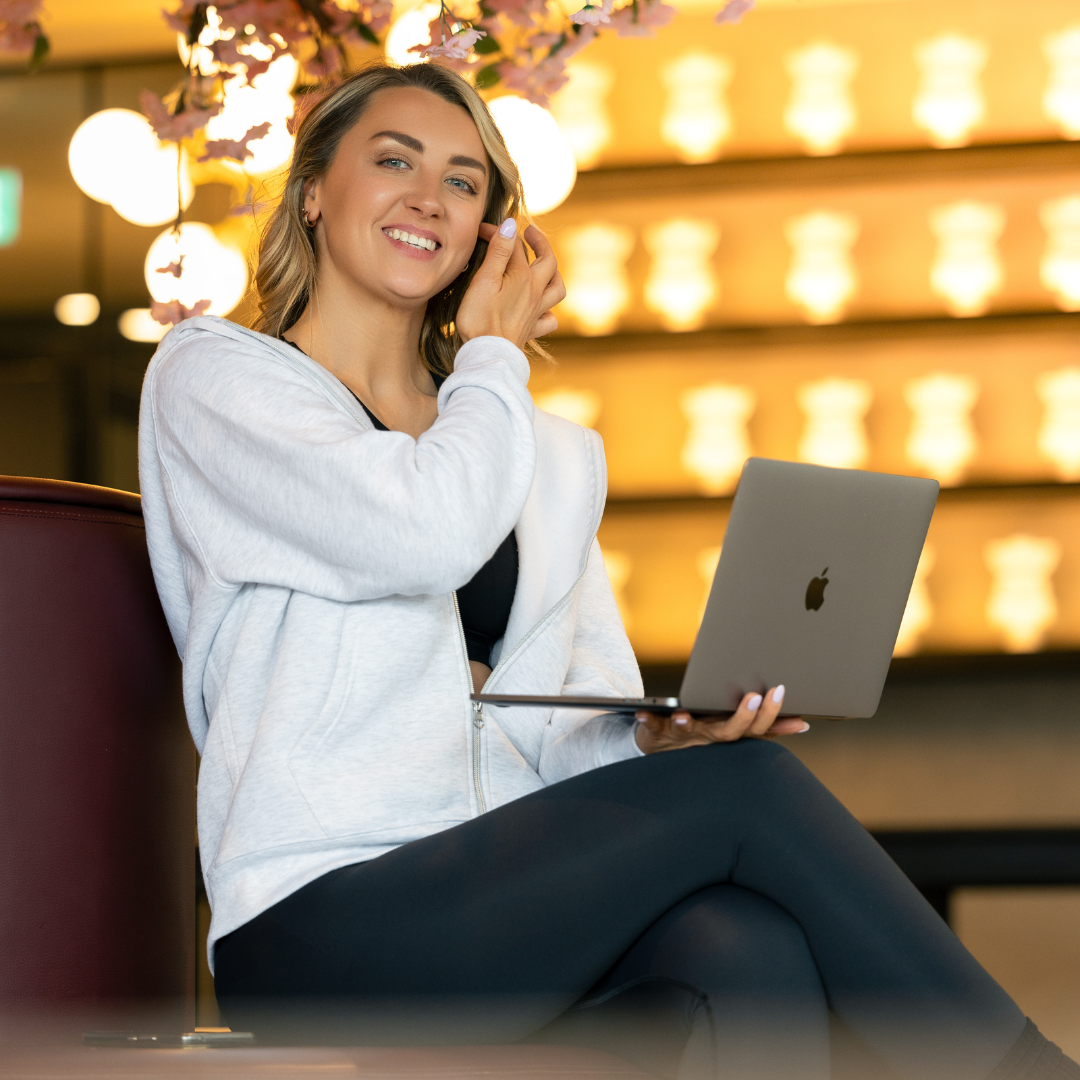Martha seated with a laptop 