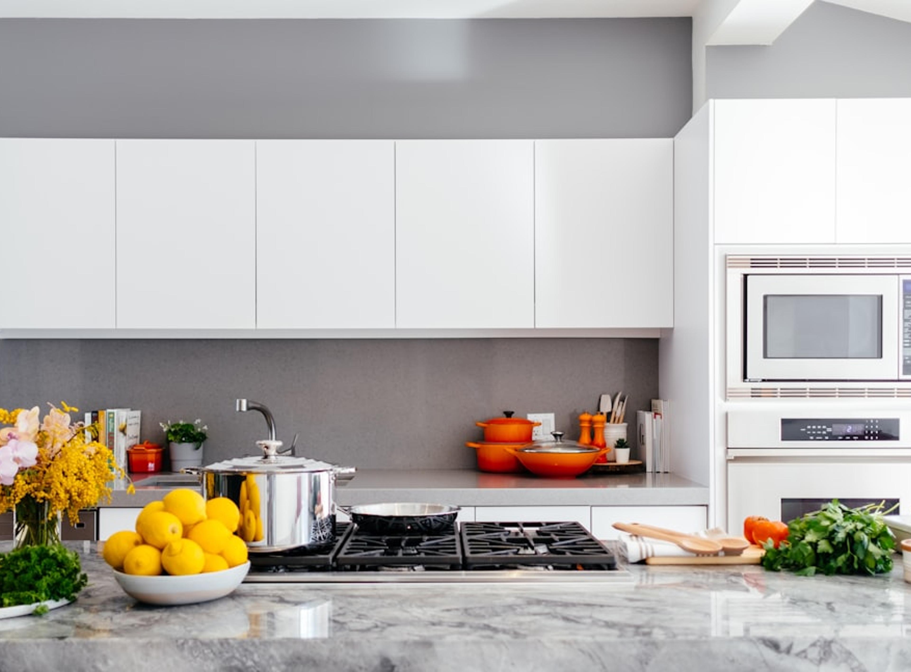 Marble countertop and backsplash in a modern white kitchen