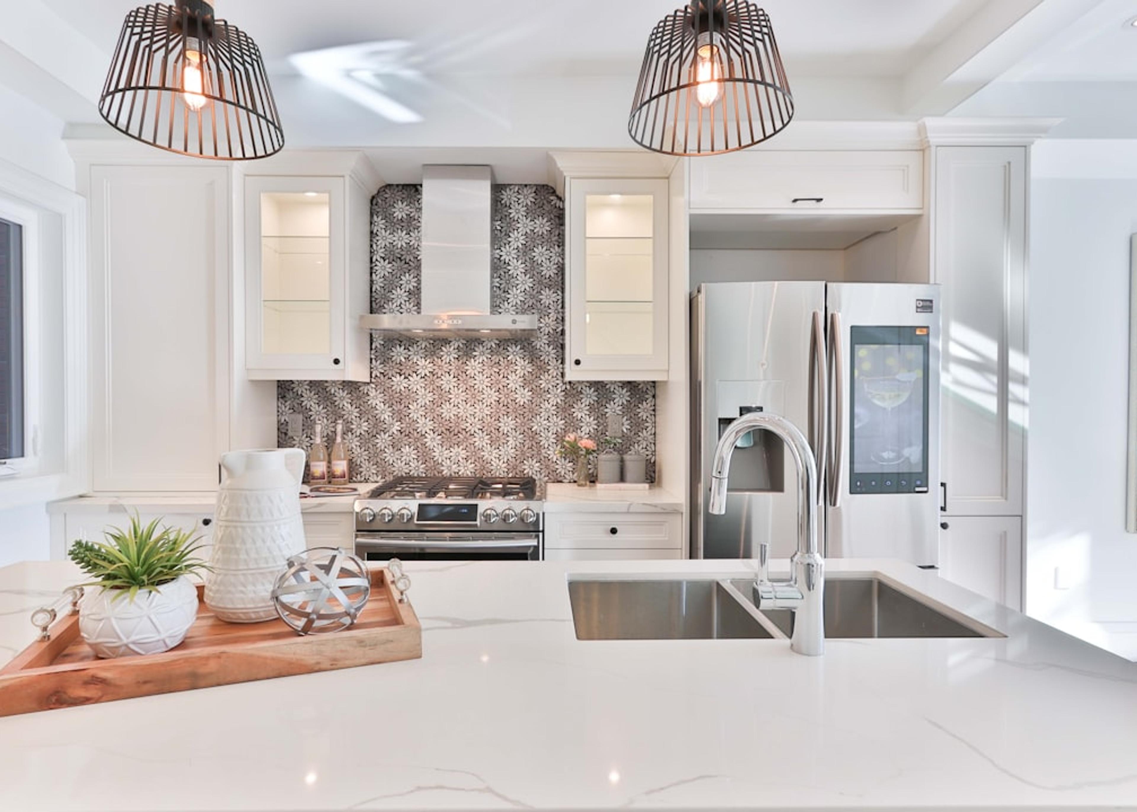 Finished white kitchen with marble backsplash and island