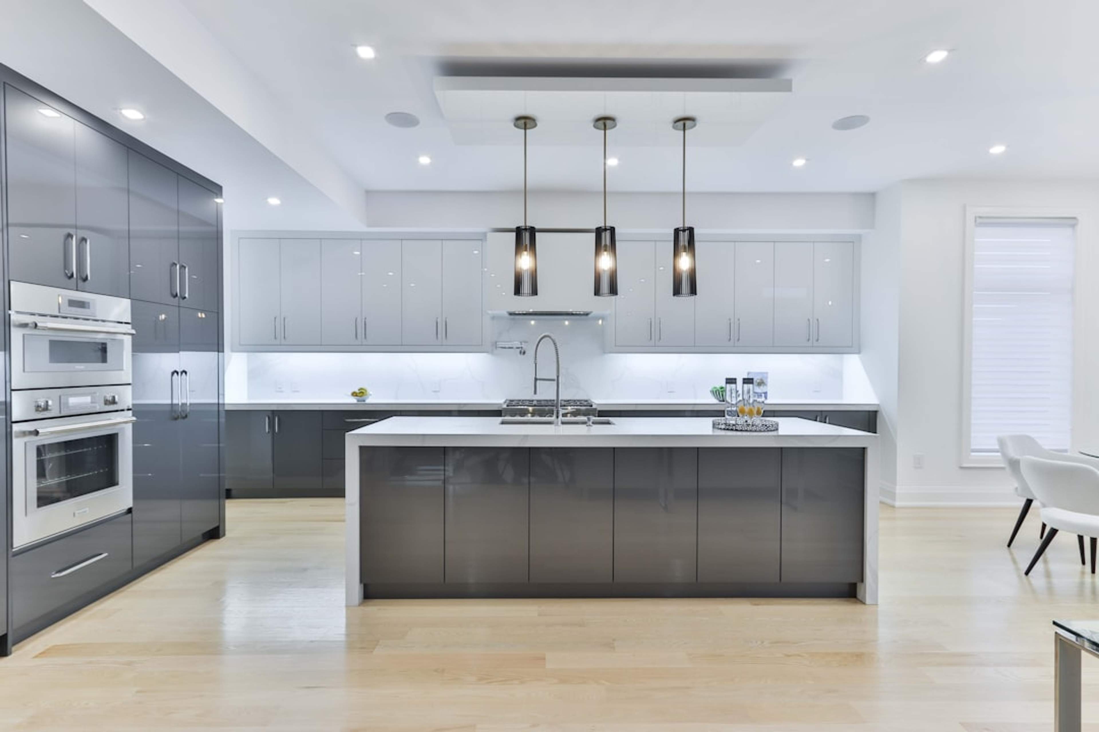 Open-plan kitchen with grand island and pendant lighting